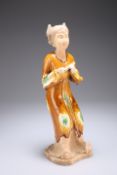 A CHINESE TANG STYLE FIGURE OF A MUSICIAN, modelled holding an instrument, ochre glazed with