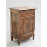 A 19TH CENTURY FRENCH OAK SIDE CABINET, the moulded rectangular top with serpentine front, above a