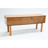 A 1970'S SCHREIBER SIDEBOARD, with six drawers with fixed metal angular handles, raised on U-