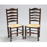 A PAIR OF LANCASHIRE RUSH-SEATED OAK LADDER-BACK SIDE CHAIRS, EARLY 19TH CENTURY, each with five-