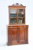 A MAHOGANY BOOKCASE CABINET, the glazed upper section with broken arch pediment, the associated base