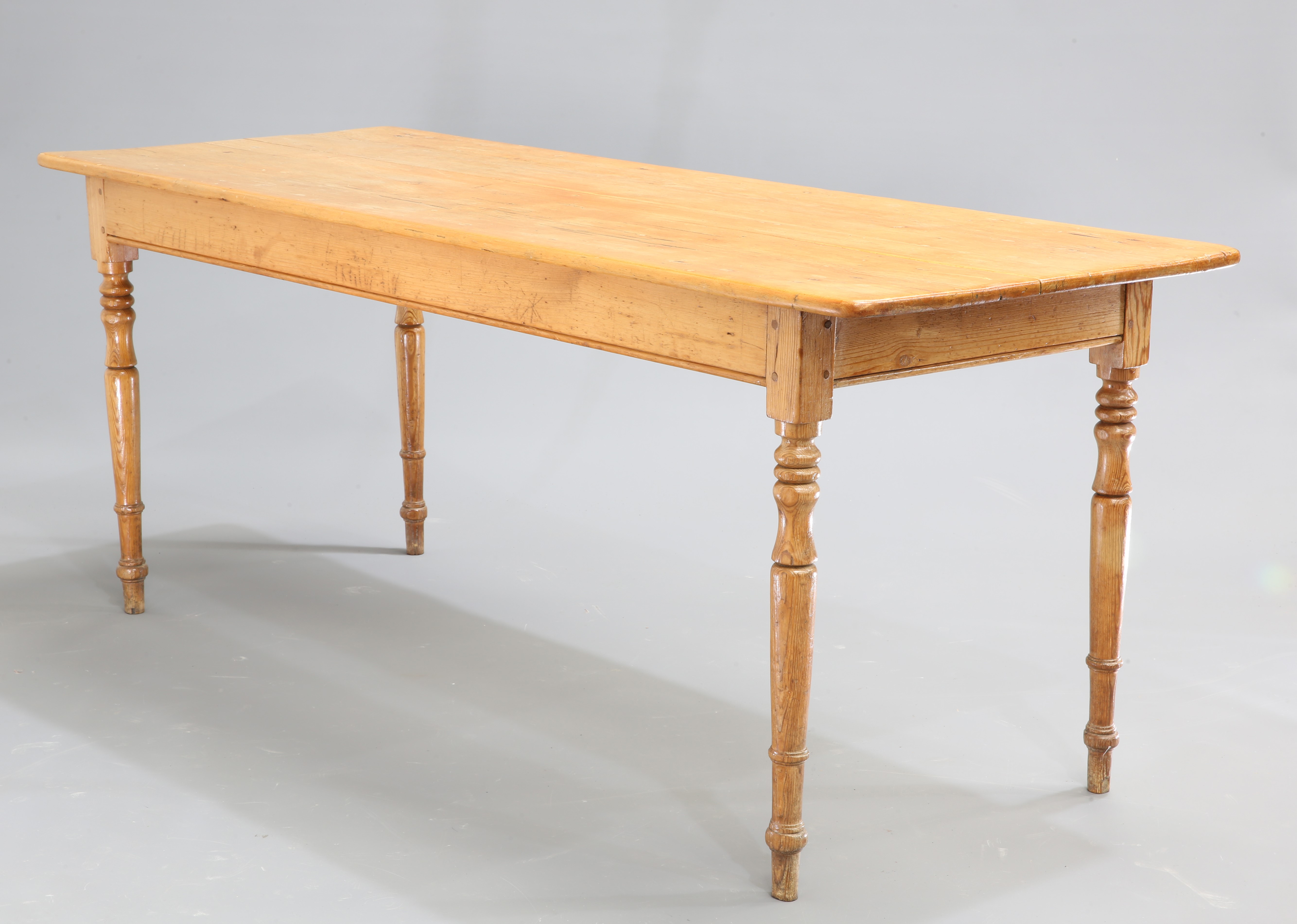 A VICTORIAN PINE DAIRY TABLE, the rectangular top raised on turned legs. 73cm high, 182cm wide, 67.