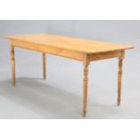 A VICTORIAN PINE DAIRY TABLE, the rectangular top raised on turned legs. 73cm high, 182cm wide, 67.