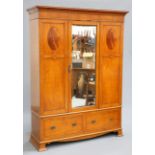 A LATE VICTORIAN SATINWOOD WARDROBE, with concave pediment over a central mirror door flanked by
