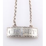 A SILVER CLARET DECANTER LABEL, marks rubbed, rectangular label with Claret surrounded by a
