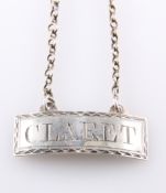 A SILVER CLARET DECANTER LABEL, marks rubbed, rectangular label with Claret surrounded by a