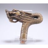A CHINESE BRASS CANE HANDLE, in the form of a dragon's head. 12cm front to back