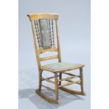 A LATE 19TH CENTURY BEECH ROCKING CHAIR, possibly American, with barley twist columns to the back.