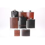 EIGHT VARIOUS HIP FLASKS, all leather covered stainless steel, with screw lids. 14cm high and