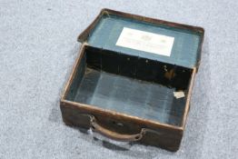 ~ A HOLLAND & HOLLAND LEATHER-BOUND CARTRIDGE CASE, lacking dividers, trade label to underside of