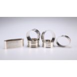 A COLLECTION OF SIX SILVER NAPKIN RINGS, comprising four circular and two oval, including one by
