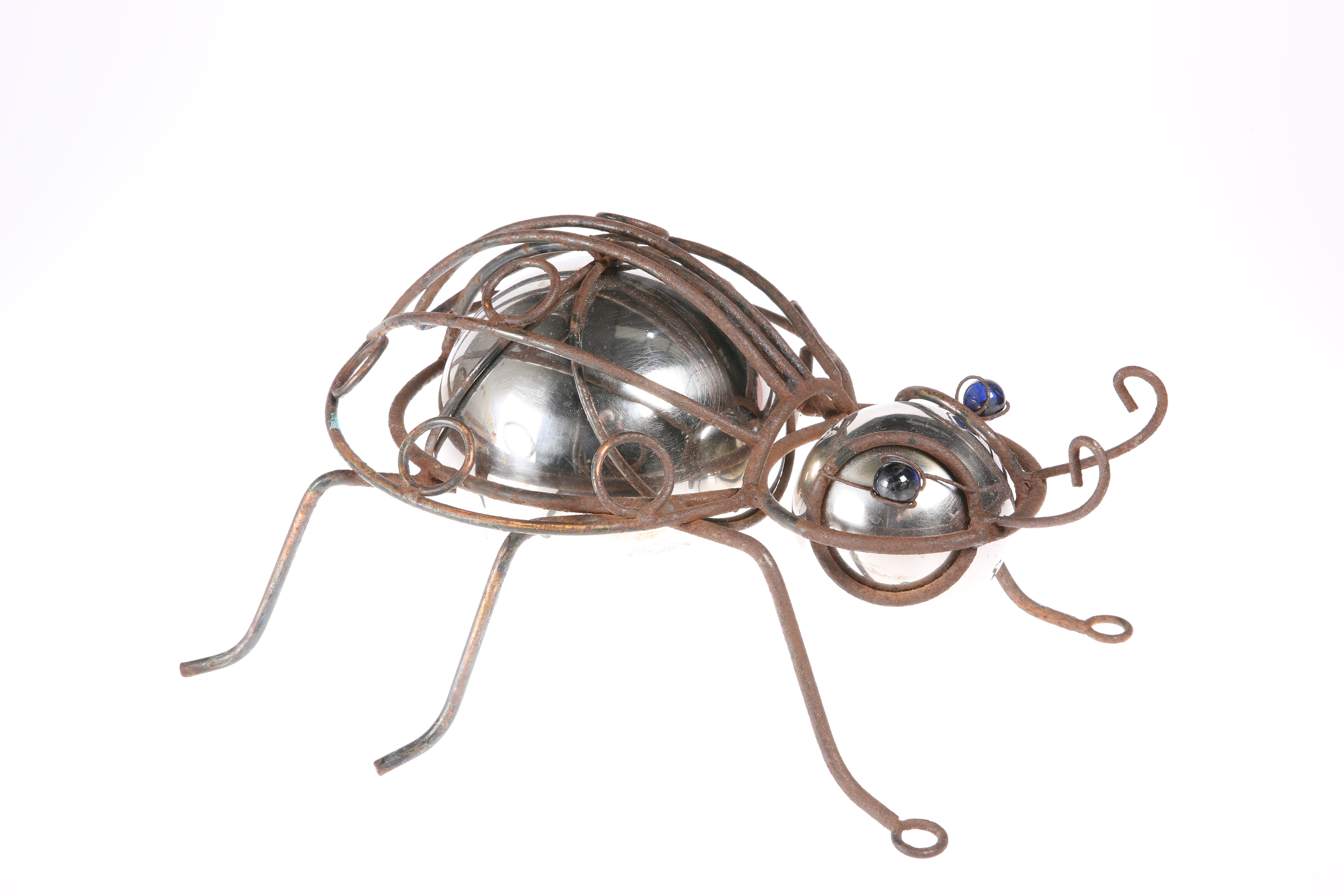 AN UNUSUAL 20TH CENTURY METAL AND GLASS MODEL OF A BEETLE, with blue glass eyes. 36cm long
