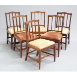 A SET OF SIX GEORGE III MAHOGANY DINING CHAIRS, each with leaf-carved crest rail and reeded bar-back