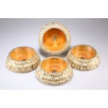 A SET OF FOUR LARGE VICTORIAN SILVER-GILT BOTTLE COASTERS, by John Waterhouse & Edward Hatfield &