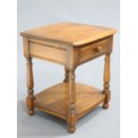 AN ERCOL GOLDEN DAWN SIDE TABLE fitted with a drawer. 47.5cm wide
