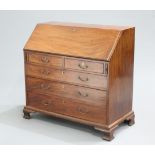 A GEORGE III MAHOGANY SLANT FRONT BUREAU, the moulded rectangular slope opening to reveal a fitted