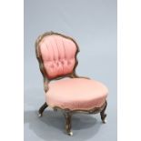A VICTORIAN WALNUT AND UPHOLSTERED NURSING CHAIR, the cartouche-shaped back with buttoned