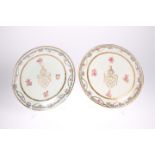 A PAIR OF PORCELAIN PLATES IN THE CHINESE EXPORT ARMORIAL STYLE, each enamel painted with a floral