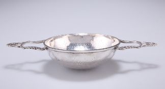 A GEORGIAN SILVER LEMON STRAINER, marks rubbed, the central pierced dished strainer with strapwork