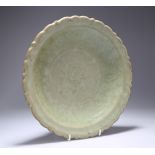 A LONGQUAN CELADON-GLAZED DISH, LATE MING DYNASTY, circular with scallop edge and ribs to the