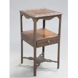 A GEORGE III OAK WASHSTAND, later carved, the now square top with blind-fretwork varved band and