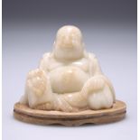 A 19TH CENTURY CHINESE SOAPSTONE FIGURE OF A BUDDHA, carved seated holding a string of beads, on