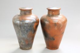 A LARGE PAIR OF SALT-GLAZED URNS, each with pierced hole to the cover. 77.5cm high