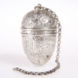 AN UNMARKED TEA INFUSER, egg shaped, chased with hatched panels and foliage. 7.5cm