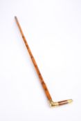 A YELLOW-METAL MOUNTED MALACCA CANE, late 19th Century, engraved with a monogram. 89.5cm