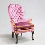 A RECENTLY RE-UPHOLSTERED SPOON-BACK ARMCHAIR, EARLY 20TH CENTURY, the deep-buttoned back above a