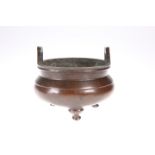 ~ A CHINESE BRONZE TRIPOD CENSER, in the Archaic manner. 11.5cm diameter, 593 gramsThe absence of