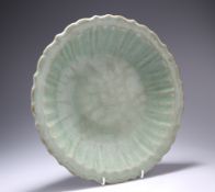 A LONGQUAN CELADON-GLAZED DISH, LATE MING DYNASTY, circular with scallop edge and ribs to the