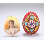 A PRISONER OF WAR BEADWORK EGG, together with A BRASS-MOUNTED PORCELAIN BROOCH, oval, printed with