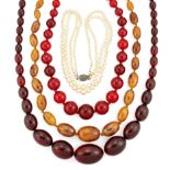 THREE FAUX AMBER NECKLACES AND A CULTURED PEARL NECKLACE,