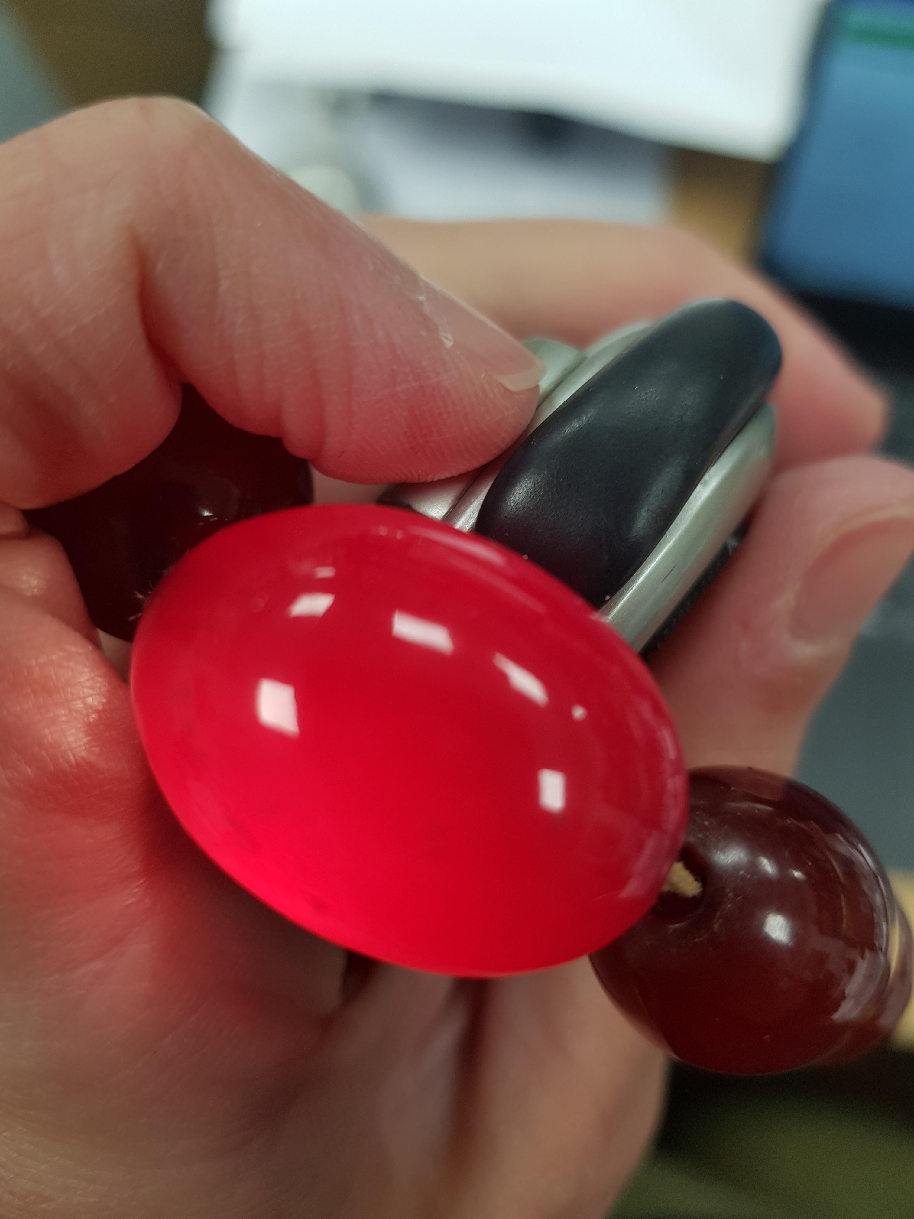 A CHERRY AMBER COLOURED BEAD NECKLACE, the graduated beads simply strung. 59 gramsThe absence of a - Image 2 of 2