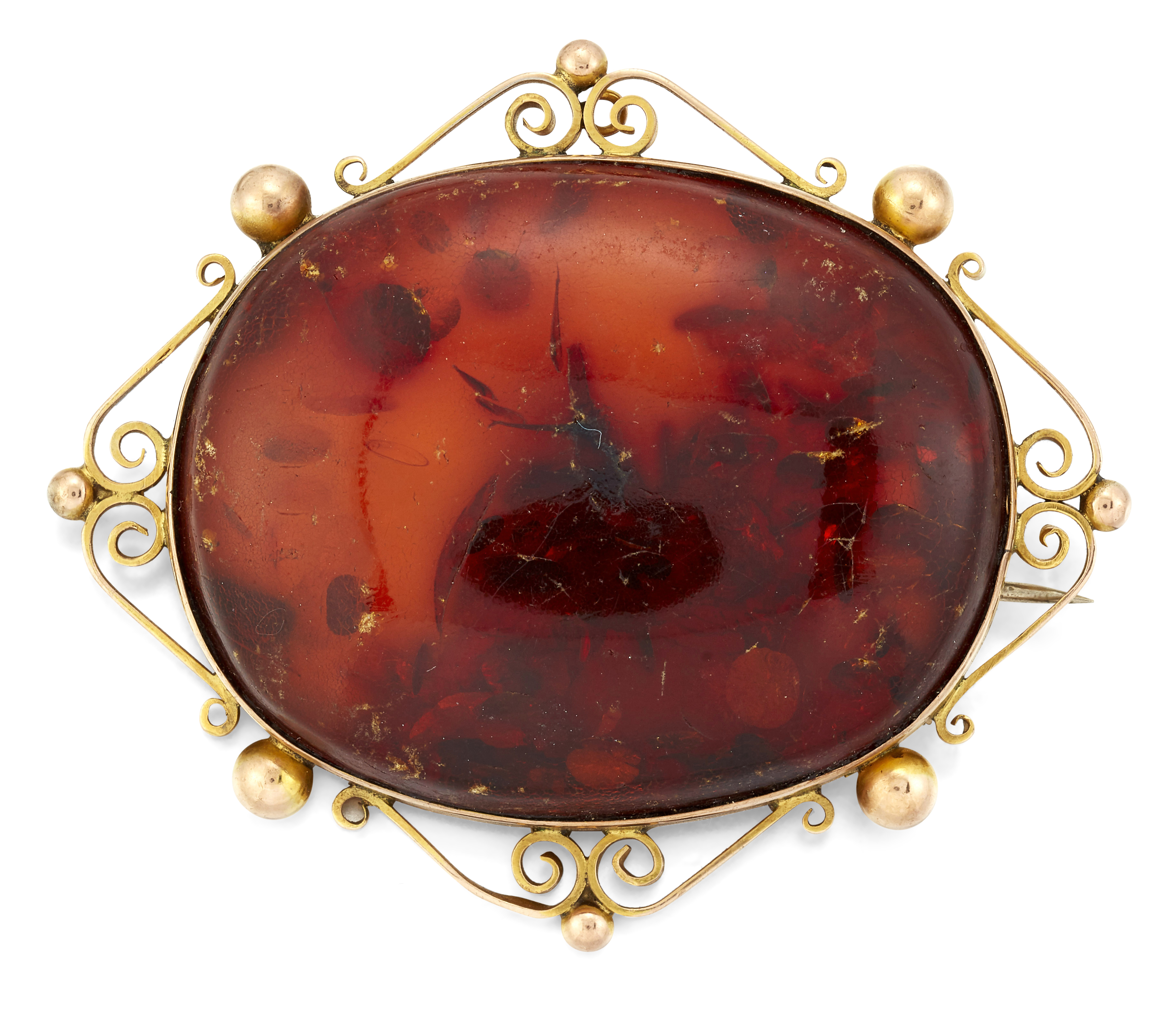 AN AMBER BROOCH,