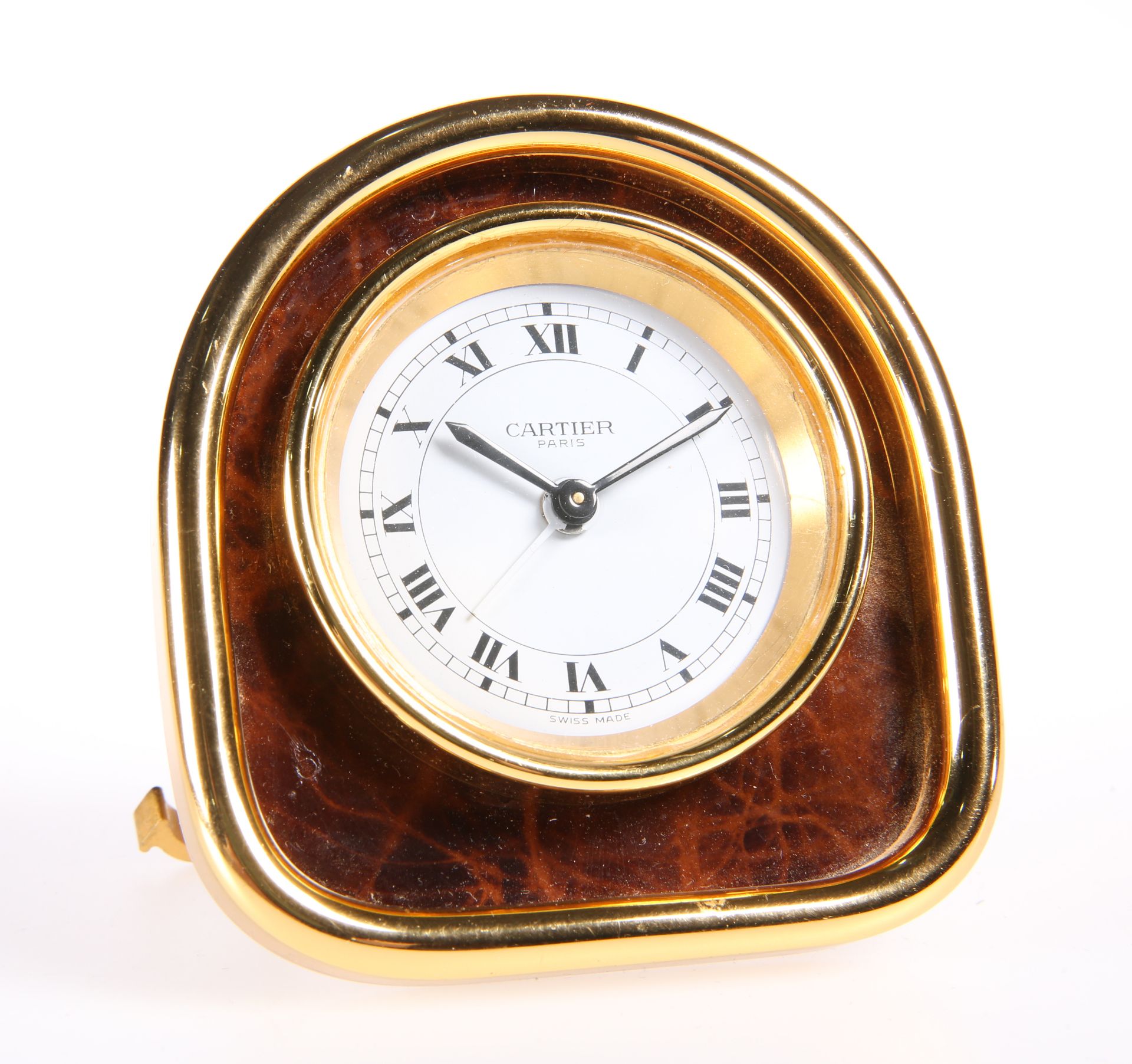 A CARTIER YELLOW-METAL STRUT CLOCK, the arch-top case housing a circular white dial, signed 'Cartier