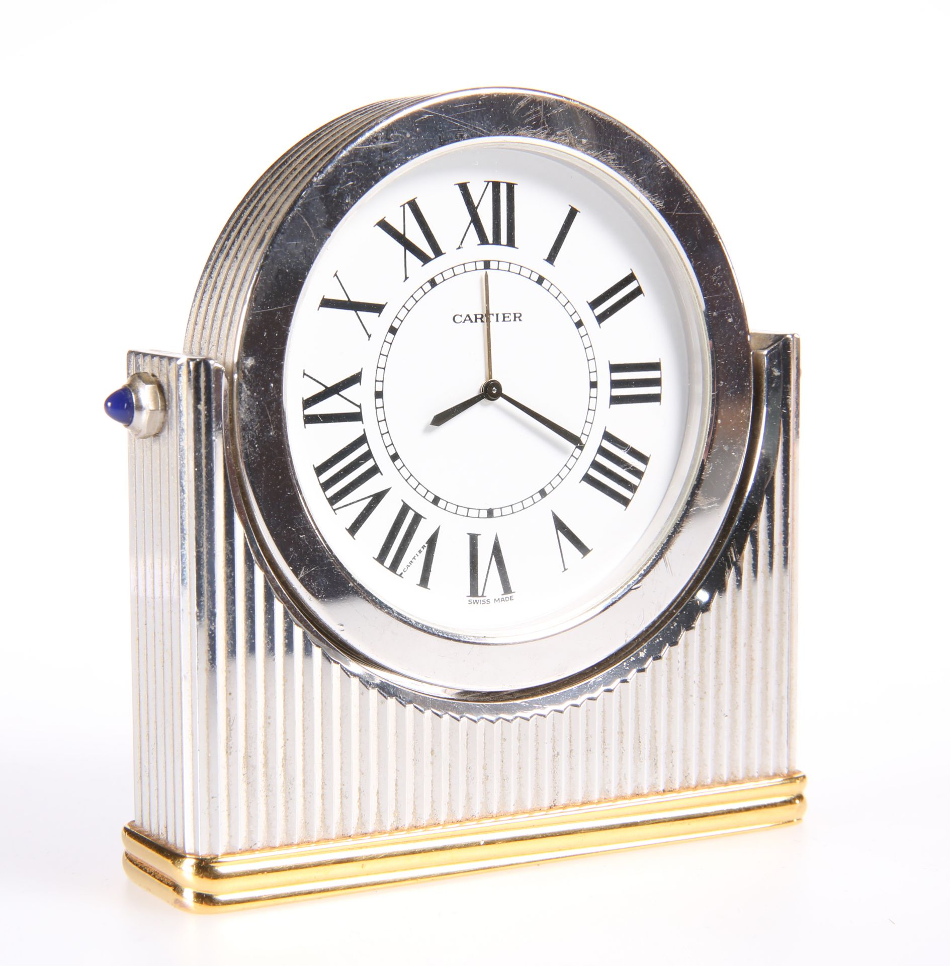 A CARTIER BI-COLOURED METAL DESK CLOCK, the reeded case with applied blue cabochons to the shoulders