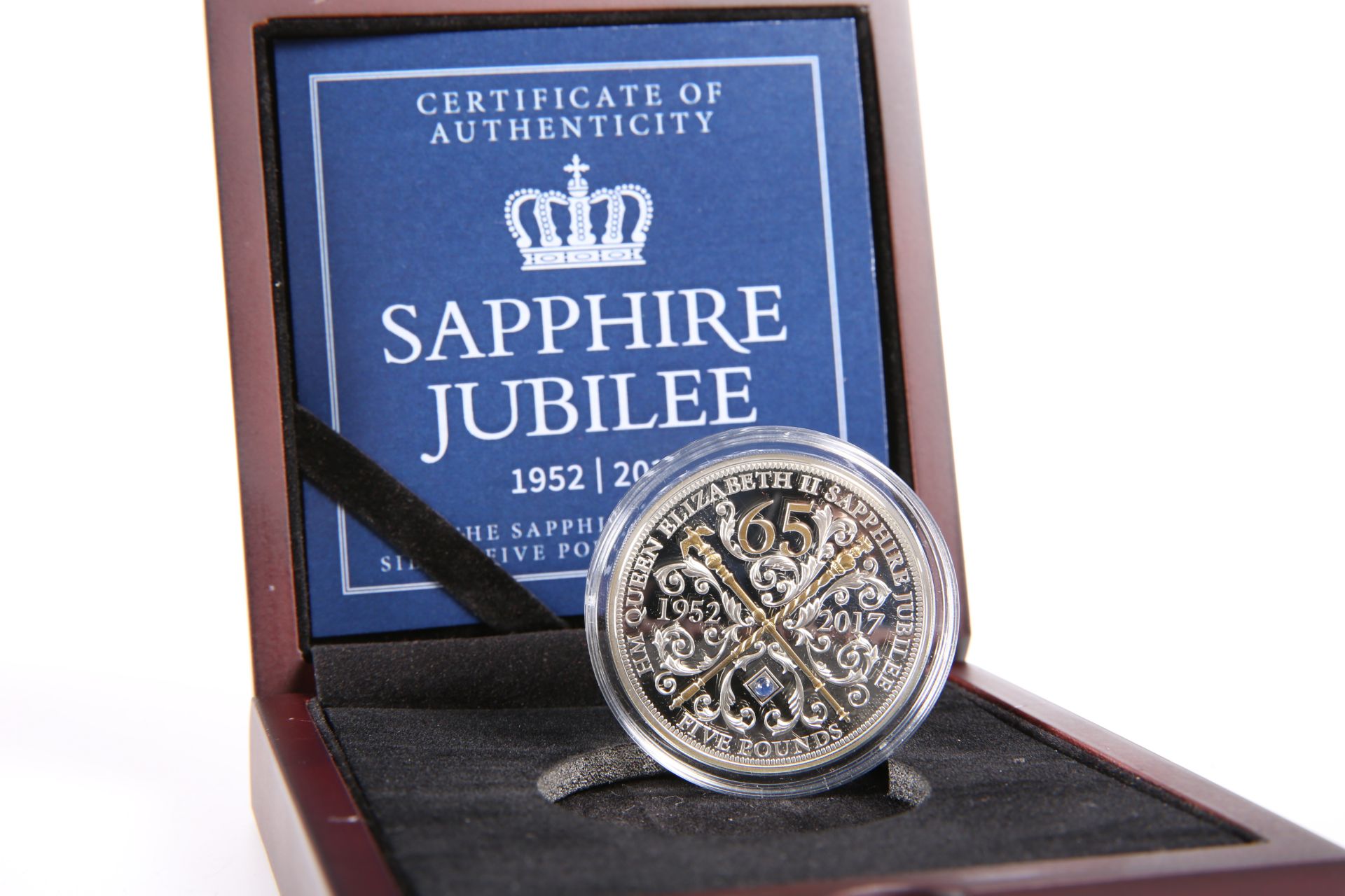 A SAPPHIRE JUBILEE SILVER FIVE POUNDS PROOF COIN WITH GENUINE SAPPHIRE, boxed with COA no. 1224