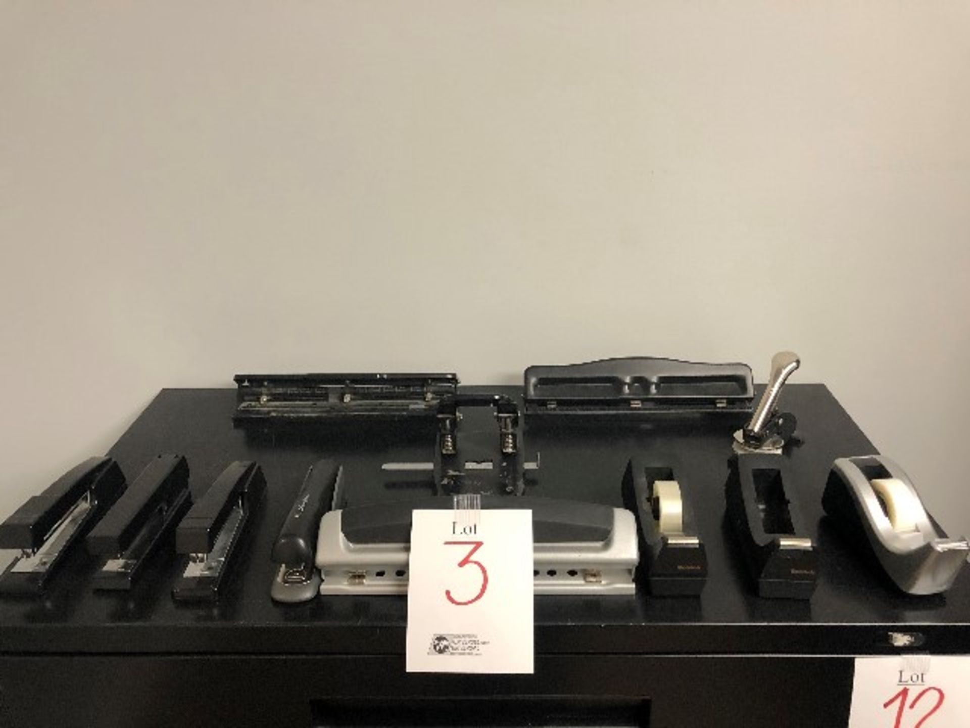 LOT: (12 pcs) Assorted staplers,hole punchers,tape dispensers,etc...,