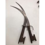 Pair of far eastern curved blade daggers with inlaid handle. Blade length 41cm