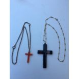 Two hardstone crucifix on gold chains