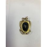 Archibald Knox folded gold pendant, Nouveau style set with black star cabochon stone, scratch marked