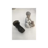 LLadro figure of boy and dog, along with a metal boot.