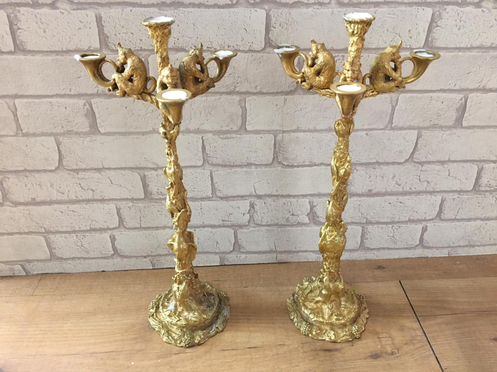 Pair of gilt bronze Fratin c1820 candleabra, the base with hunting weapons and swords, the sticks