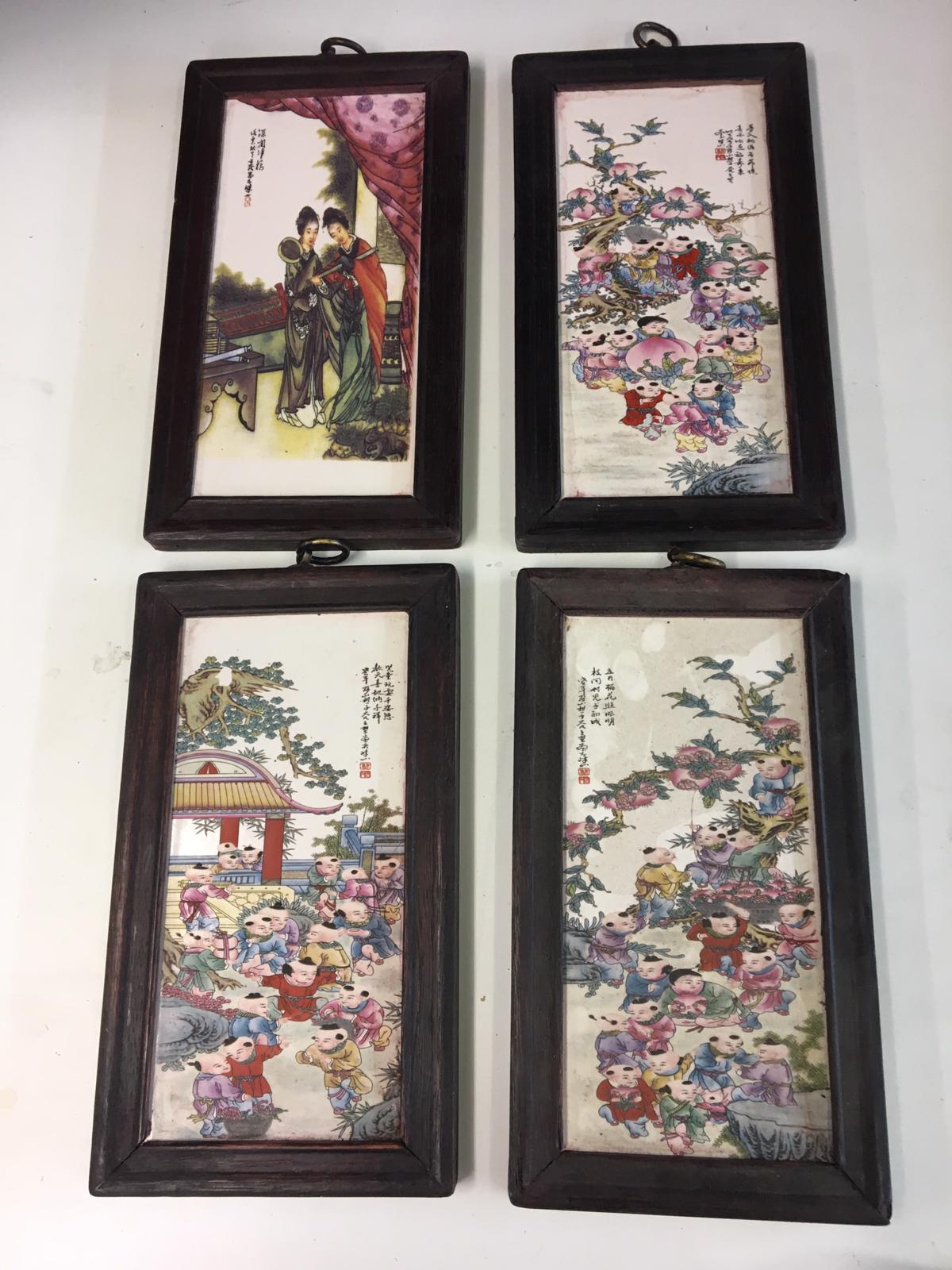 Four framed chinese wall panels.