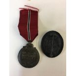 WWII Style German Eastern front medal and black wounds badge.