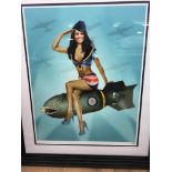 Framed and glazed Ltd Ed Print Of Kate Middleton sitting on a dropped Bomb.