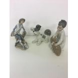 Three Lladro figures to include dog, boy with dog, and boy with dog