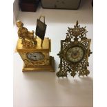 Two 19th century clocks, one with a woman on top painting with removable picture from easel